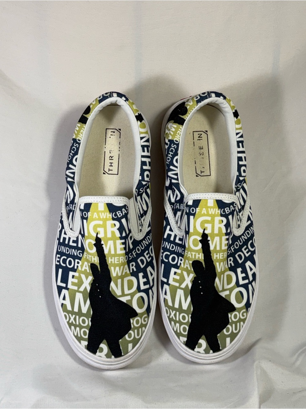 Three in Hamilton size 9.5 Slip-On Canvas Shoes with Navy & Olive Graphic Print